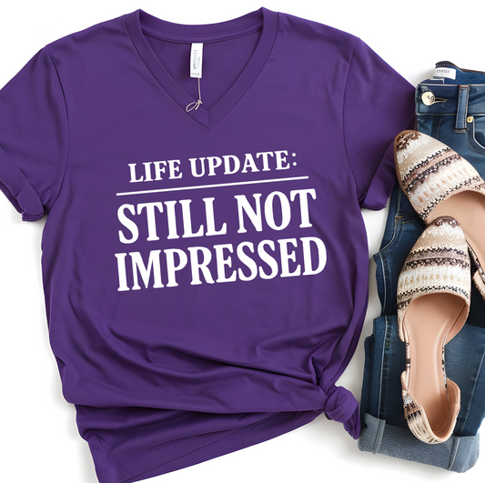 Humorous V-Neck Tee. Life Update: Still Not Impressed, Funny Shirt, Gift for Friends, Casual Wear, Everyday Humor, Comical Fashion